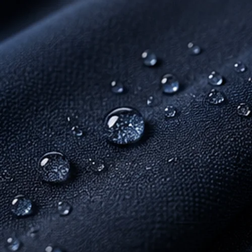 Water beading on the surface of navy cloth